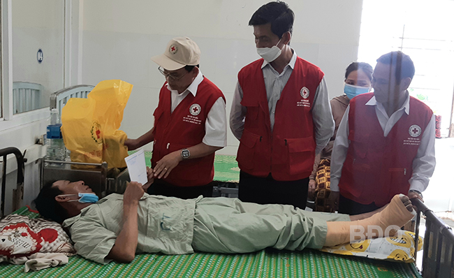 Lãnh đạo Hội CTĐ tỉnh thăm hỏi và trao hỗ trợ nạn nhân Trần Văn Đạt ở xã Nhơn Hòa, TX An Nhơn đang điều trị tại BVĐK tỉnh vào sáng 16.9. Ảnh: N.T